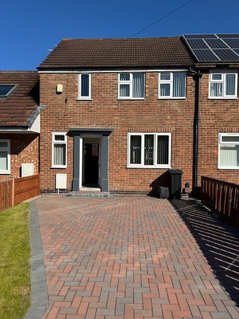 Red cottage home with landscaping